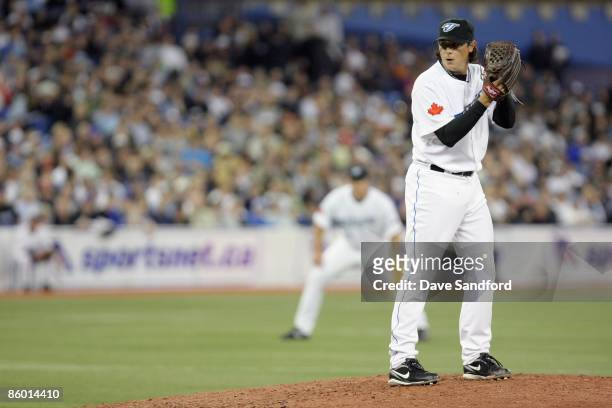Scott Downs of the Toronto Blue Jays lines up the pitch during the Opening Day game against the Detroit Tigers at the Rogers Centre on April 6, 2009...