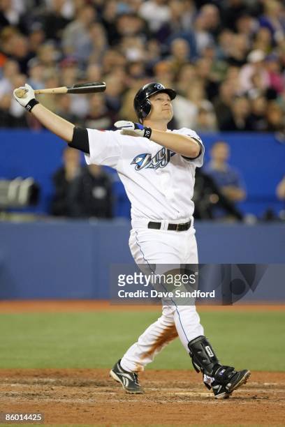 Adam Lind of the Toronto Blue Jays swings at the pitch during the Opening Day game against the Detroit Tigers at the Rogers Centre on April 6, 2009...