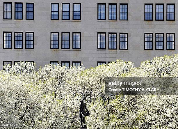 Luxury department store Bergdorf Goodman and trees in bloom serve as a backdrop for the statue of Pomona, Roman goddess of orchards, in New York's...