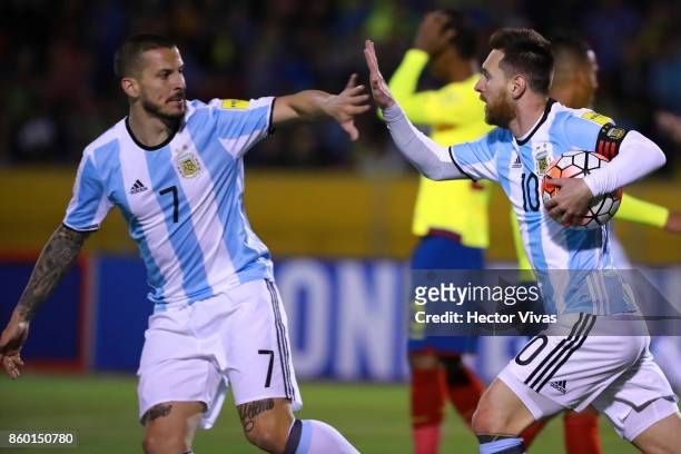 Lionel Messi of Argentina celebrates with teammate Dario Benedetto after scoring the first goal of his team during a match between Ecuador and...
