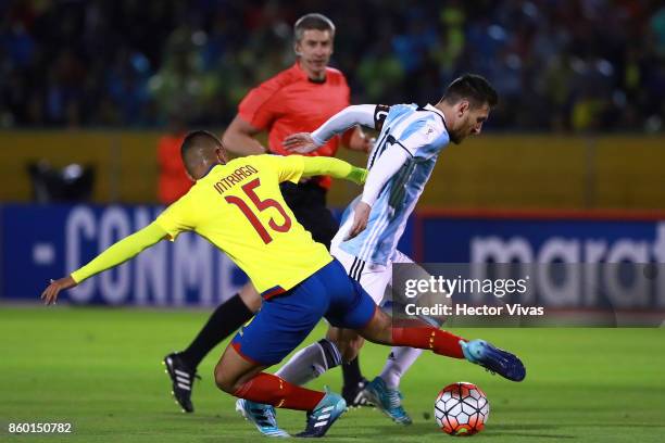 Jefferson Intriago of Ecuador struggles for the ball with Lionel Messi of Argentina during a match between Ecuador and Argentina as part of FIFA 2018...