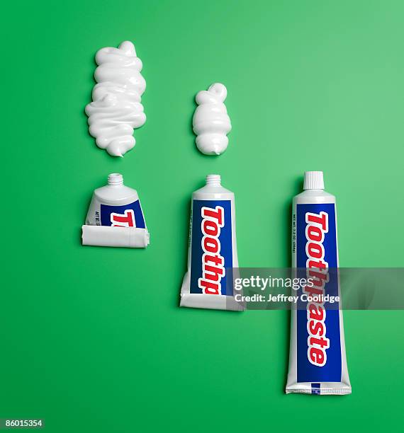 three toothpaste tubes and toothpaste - zahnpasta stock-fotos und bilder