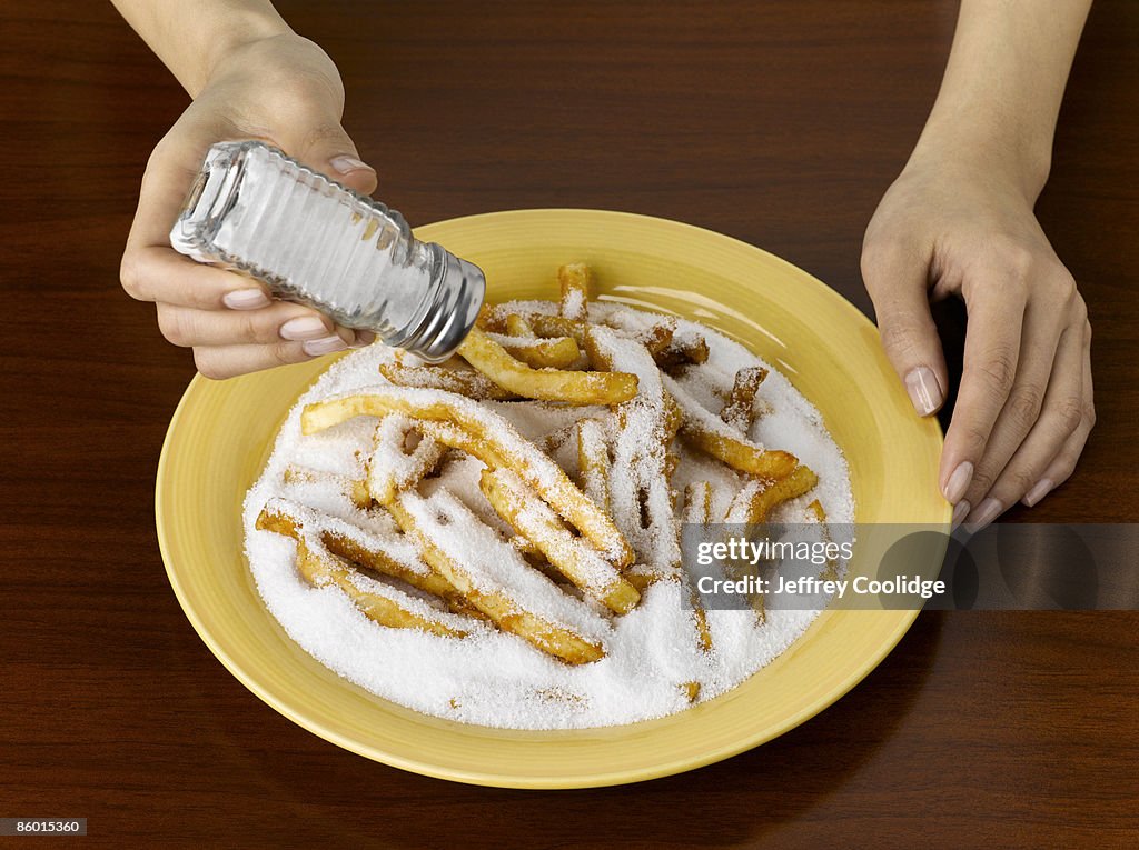 Woman Salting Junk Food