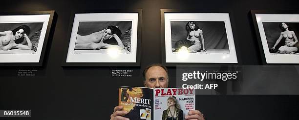 Photographer Martin H.M. Schreiber poses at Galery Art District in Amsterdam on April 17 with an issue of Playboy magazine including the nude...