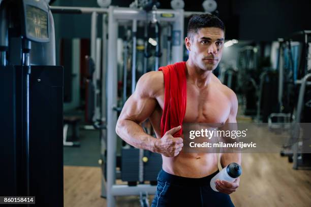 muscular fit man exercising in a gym - arab bodybuilder stock pictures, royalty-free photos & images