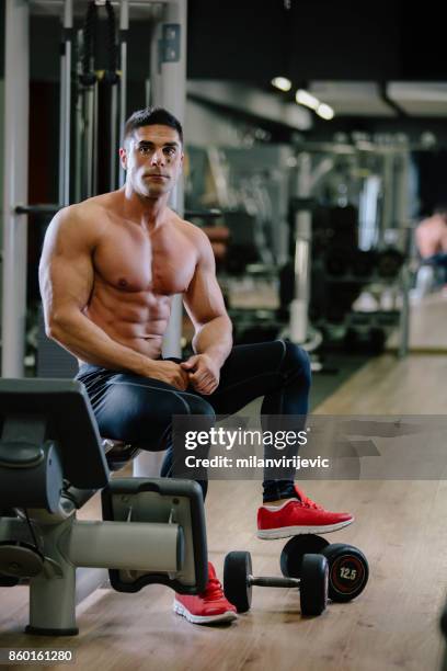 muscular fit man exercising in a gym - arab bodybuilder stock pictures, royalty-free photos & images