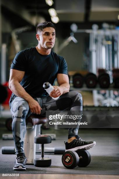 muscular fit man exercising in a gym - arab bodybuilder stock pictures, royalty-free photos & images