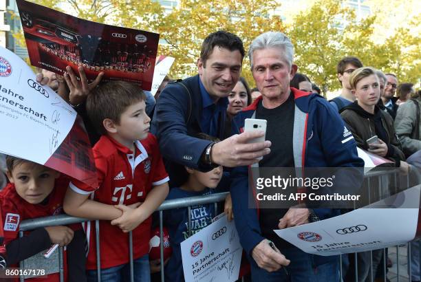 Bayern Munich's new headcoach Jupp Heynckes poses for selfies with supporters after a car handover event at the Audi headquarters in Ingolstadt,...
