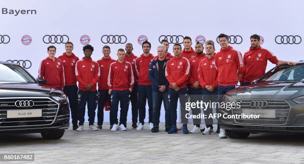 Bayern Munich's new headcoach Jupp Heynckes poses with his players during a car handover event at the Audi headquarters in Ingolstadt, southern...