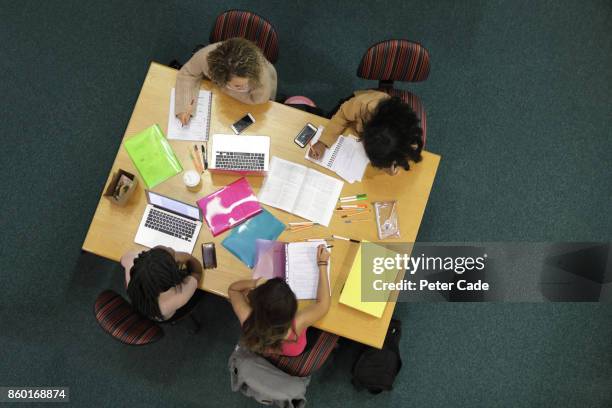 students sat around table studying - sattel bildbanksfoton och bilder