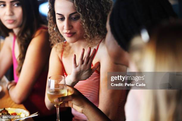 young woman refusing wine in restaurant - alcoholic drinks stock pictures, royalty-free photos & images