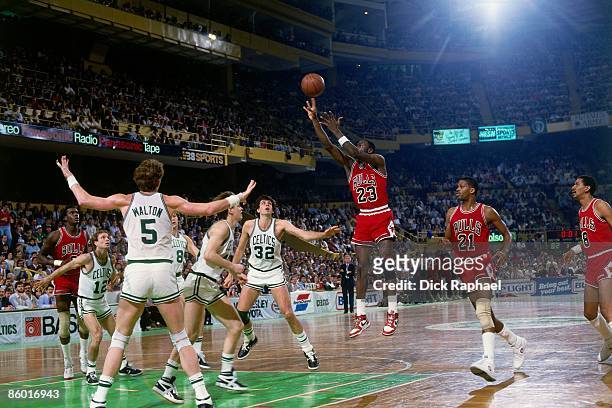 Michael Jordan of the Chicago Bulls shoots a jump shot against Danny Ainge of the Boston Celtics during an NBA game played in 1986 at the Boston...