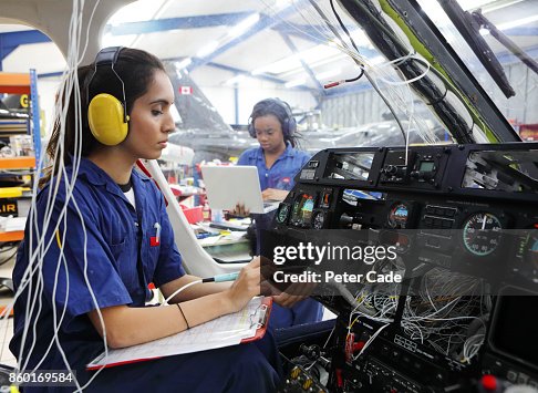 Young female engineers working with helicopters Young female engineers working with helicopters