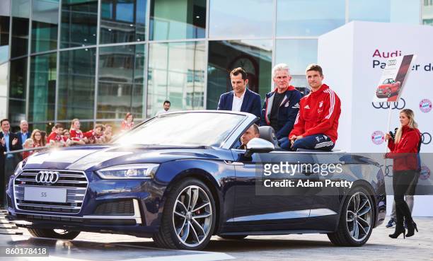 Hasan Salihamidzic sporting director Jupp Heynckes head coach and Thomas Mueller of Bayern Muenchen ride in the back of an Audi S5 during the FC...