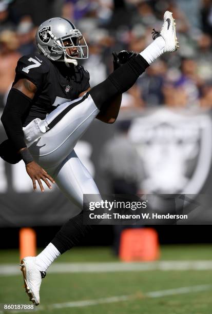 Marquette King of the Oakland Raiders punts the ball against the Baltimore Ravens during the second quarter of their NFL football game at...