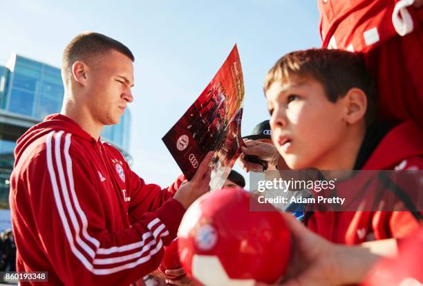 Joshua Kimmich of Bayern Muenchen signs autographs for fans during the FC Bayern Muenchen New Car Handover at the Audi Forum on October 11, 2017 in...