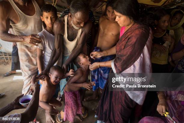 Vaccinators give the oral cholera vaccine to Rohingya October 11, in Thainkhali refugee camp Cox's Bazar, Bangladesh. A massive cholera immunization...