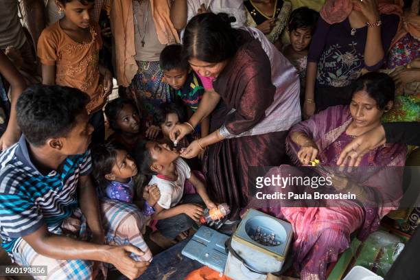 Vaccinators give the oral cholera vaccine to Rohingya October 11, in Thainkhali refugee camp Cox's Bazar, Bangladesh. A massive cholera immunization...