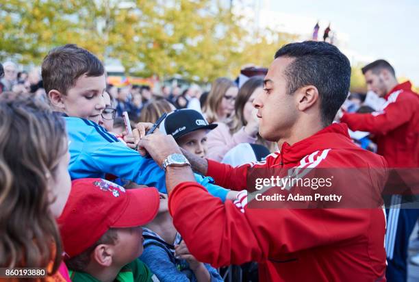 Thiago of Bayern Muenchen signs autographs for fans during the FC Bayern Muenchen New Car Handover at the Audi Forum on October 11, 2017 in...