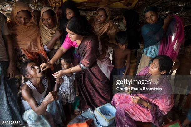 Vaccinators give the oral cholera vaccine to Rohingya October 11, in Thainkhali refugee camp Cox's Bazar, Bangladesh. A massive cholera immunization...