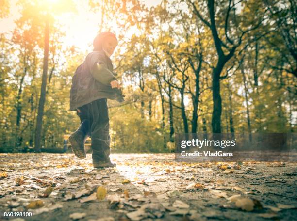 boy in the park - russia rain boots imagens e fotografias de stock