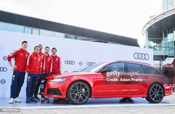 Robert Lewandowski, Thiago, Jerome Boateng, Sven Ulreich and Mats Hummels pose with their car during the FC Bayern Muenchen New Car Handover at the...