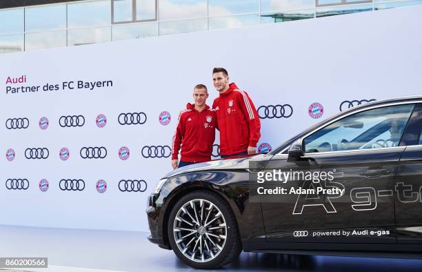 Joshua Kimmich and Niklas Suele of FC Bayern Muenchen pose with their car during the FC Bayern Muenchen New Car Handover at the Audi Forum on October...