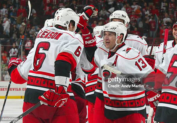 Tim Gleason of the Carolina Hurricanes is congratulated by his teammate Ray Whitney after scoring the winning goal in overtime against the New Jersey...