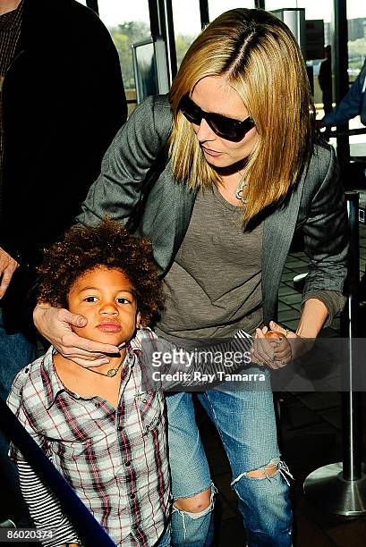 Television personality Heidi Klum and her son Henry Samuel enter the LaGuardia Airport on April 17, 2009 in New York City.