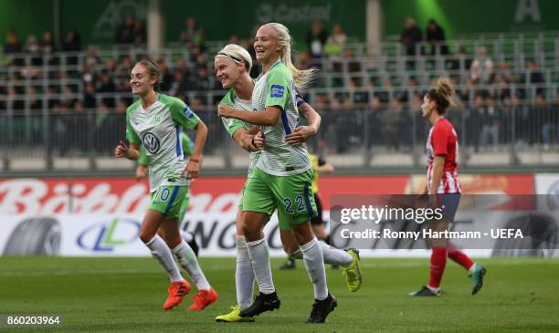 Pernille Harder of Wolfsburg celebrates after scoring with Nilla Fischer and Tessa Wullaert of Wolfsburg during the UEFA Women Champions League Round...
