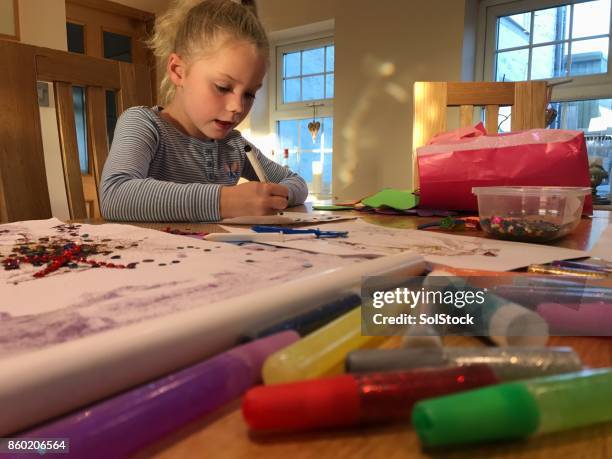 little girl colouring in kitchen table - sparkle children stock pictures, royalty-free photos & images