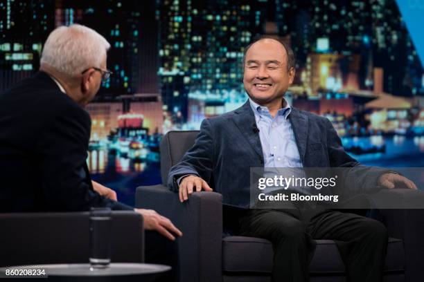 Masayoshi Son, chairman and chief executive officer of SoftBank Group Corp., right, smiles during an interview on The David Rubenstein Show in New...