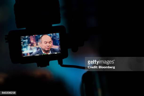 Masayoshi Son, chairman and chief executive officer of SoftBank Group Corp., is seen on a video camera monitor during an interview on The David...