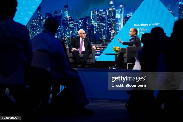 Masayoshi Son, chairman and chief executive officer of SoftBank Group Corp., right, speaks as David Rubenstein, co-chief executive officer of the...