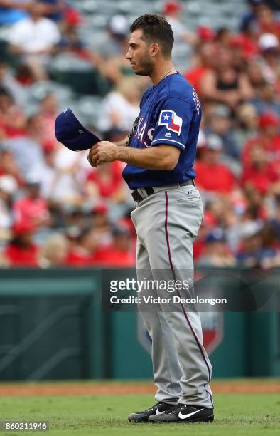 Pitcher Miguel Gonzalez of the Texas Rangers looks on during the third inning of the MLB game against the Los Angeles Angels of Anaheim at Angel...