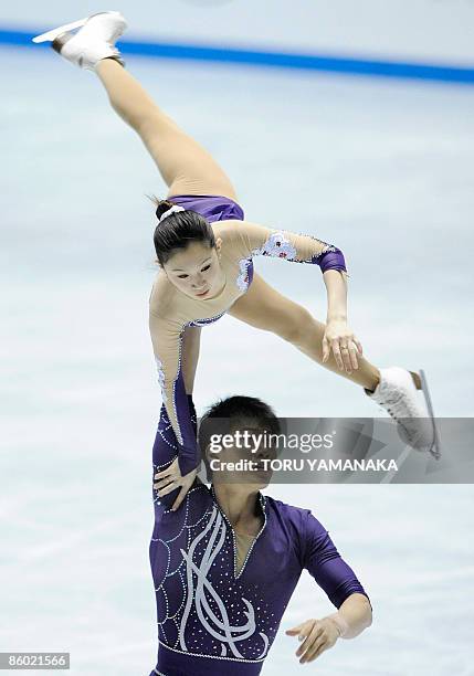 Chinese skater Zhang Hao lifts his partner Zhang Dan during their free skating in the pair event of the World Team Trophy figure skating in Tokyo on...