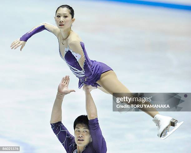 Chinese skater Zhang Hao lifts his partner Zhang Dan during their free skating in the pair event of the World Team Trophy figure skating in Tokyo on...