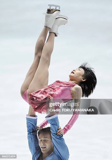 Russian skater Alexander Smirnov lifts his partner Yuko Kavaguti during their free skating in the pair event of the World Team Trophy figure skating...