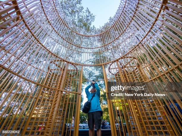 Spectator takes photos inside the instillation titled Good Fences Make Good Neighbors created by Chinese contemporary artist and activist Ai Weiwei...