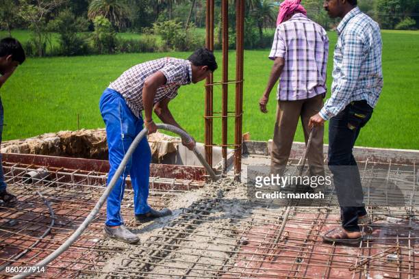 indian construction worker using a rod vibrator - vibrator stock pictures, royalty-free photos & images
