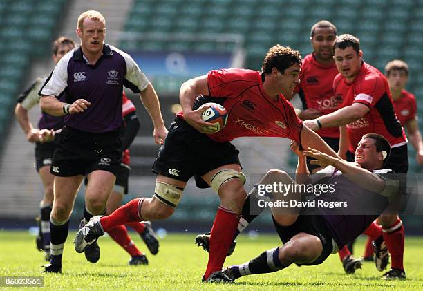 Andries Pretorious of Hartpury is hauled down by Sam Wilkes of Clifton during the EDF Energy Intermediate Cup Final between Hartpury College and...