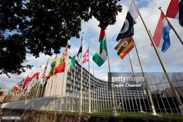 Flags from several countries float in front of the headquarters of the United Nations Educational, Scientific and Cultural Organization on October...