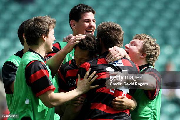 Dan Norton of Moseley is congratulated by teammates after scoring a try during the EDF Energy National Trophy Final between Leeds Carnegie and...