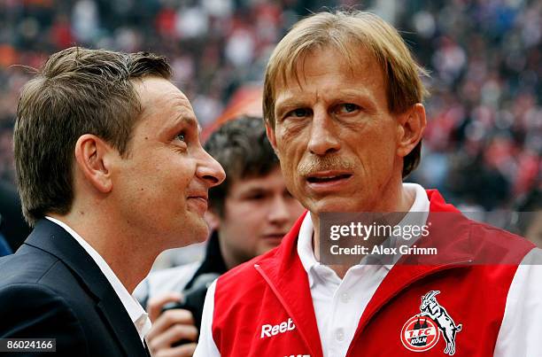 Head coach Christoph Daum of Koeln chats with manager Horst Heldt of Stuttgart before the Bundesliga match between 1.FC Koeln and VfB Stuttgart at...