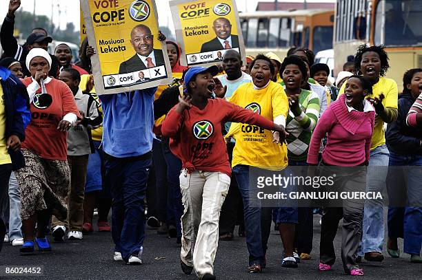South African political party COPE supporters hold up banners of their leader Mosiuoa Lekota on April 18, 2009 as they arrive at the stadium in...