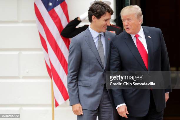 President Donald Trump and Canadian Prime Minister Justin Trudeau pose for photographs after Trudeau's arrival at the White House October 11, 2017 in...