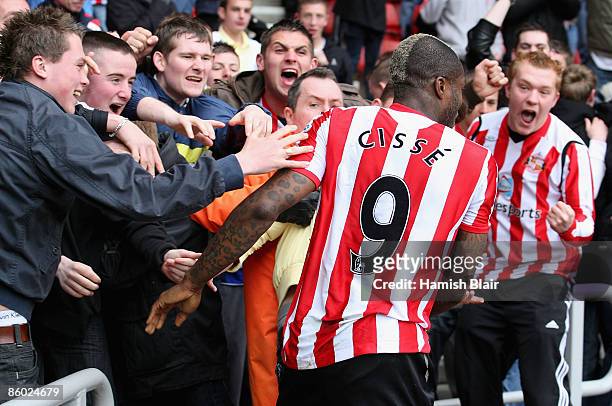 Djibril Cisse of Sunderland celebrates with fans after scoring his team's first goal during the Barclays Premier League match between Sunderland and...