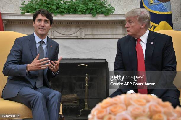 President Donald Trump listens to Canadian Prime Minister Justin Trudeau during their meeting at the White House in Washington, DC, on October 11,...