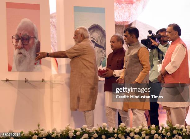 Prime Minister Narendra Modi pays tributes to Nanaji Deshmukh, Jaiprakash Narayan, with Union Minister of the State Government-Agriculture, Farmers...