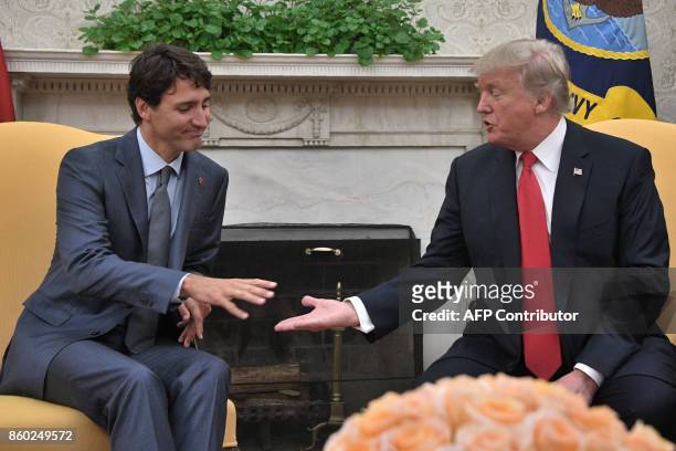 President Donald Trump shakes hands with Canadian Prime Minister Justin Trudeau during their meeting at the White House in Washington, DC, on October...